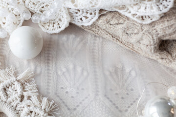 Fototapeta na wymiar Beautiful delicate white christmas background with beads, balls, new year decor