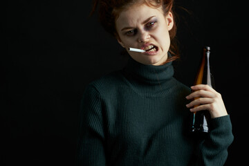 Obraz premium woman with bottle of alcohol bruises under eyes changes depression dark background