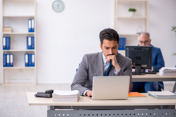 Two male colleagues working in the office