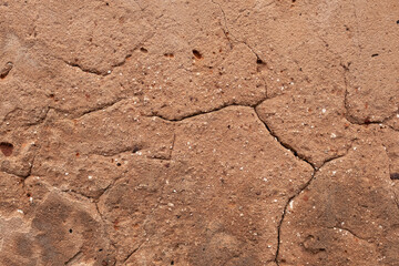 The texture of a rough clay wall.