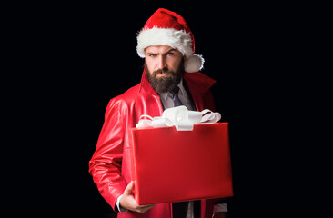 Bearded modern santa on black background wishes Merry christmas and Happy new year. Christmas gift.