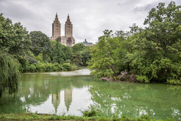 New York City Manhattan Central Park panorama in summer and lake with skyscrapers and colorful trees with reflection