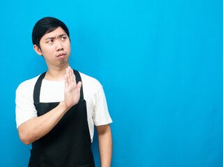 Man wearing apron gesture deny show hand up at copy space