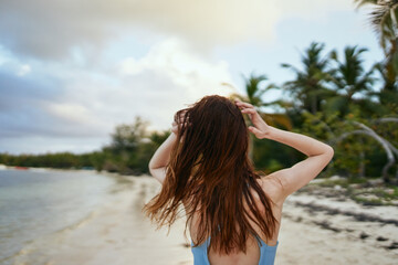 Naklejka premium woman in blue swimsuit on the beach island lifestyle