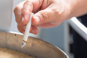 stop smoking or quit smoking concept, man hand discarding left-over cigarette to ashtray