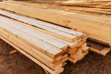 Edged boards on the ground. Stack of edged board on the construction site.