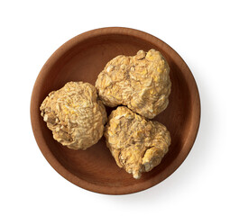 Dried yellow Maca in the wooden bowl, isolated on white background, top view