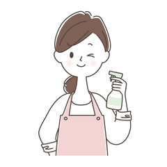 スプレー洗剤を持ってウインクする主婦