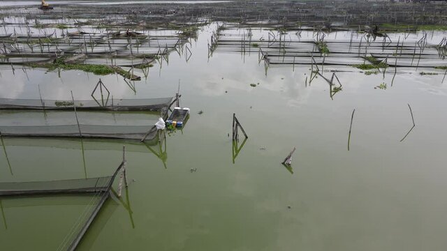 Aerial view of traditional floating fish pond on swamp in Indonesia