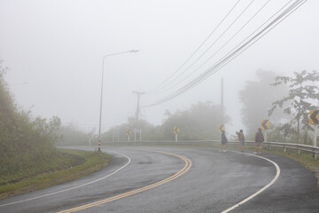 Fototapeta premium Doi Phu Kha Viewpoint on 1715 road, Nan province, Thailand with full of mist during rainy season.