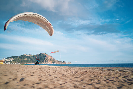 Paragliding on the beach, leisure activity.
