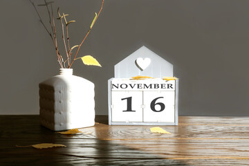 Calendar for November 16: name of the month in English, number 16, birch branch with one yellow...