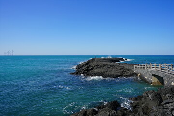 a seascape with a seaside bridge