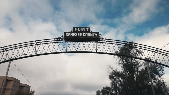 Flint, Michigan city sign with Genesse County. Video shot with gimbal walking towards sign.