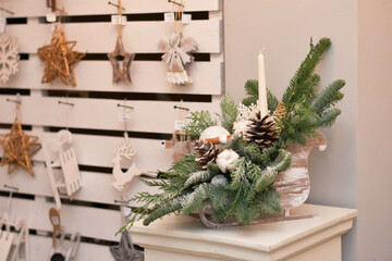 Eco christmas table decoration with candle, lobes and cones in wood sleight.