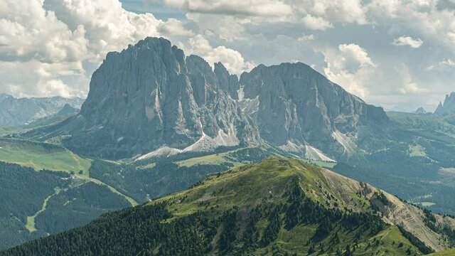 Timelapse of Sassolungo a mountain in the dolomites in South Tyrol with a hight of 3,181 meters. In the foreground you can see the Val Gardena. The timelaspe was made on a warm summer day.