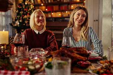 Two female friends are gathering for christmas holiday