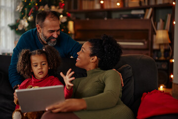 Mixed race family using digital tablet