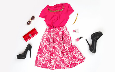 Pink dress with shoes. Individual clothes on the shelf. Women's clothing and accessories. Evening...