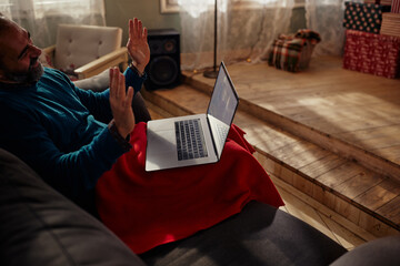 Middle age man having video call at home