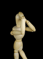 Wooden mannequin thinking about problem isolated on black background