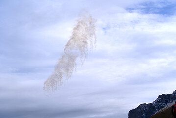 Flare smoke in the air at Axalp air show of Swiss Air Force on a grey and cloudy autumn day. Photo taken October 19th, 2021, Brienz, Switzerland.