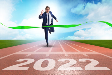 Businessman running to the 2022 year