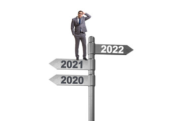 Fototapeta premium Businessman on the signpost from 2021 to 2022