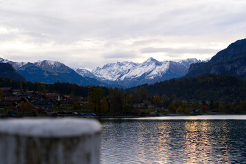 Lake Brienz with panorama mountain view on a cloudy autumn day with autumn trees. Photo taken October 19th, 2021, Brienz, Switzerland.