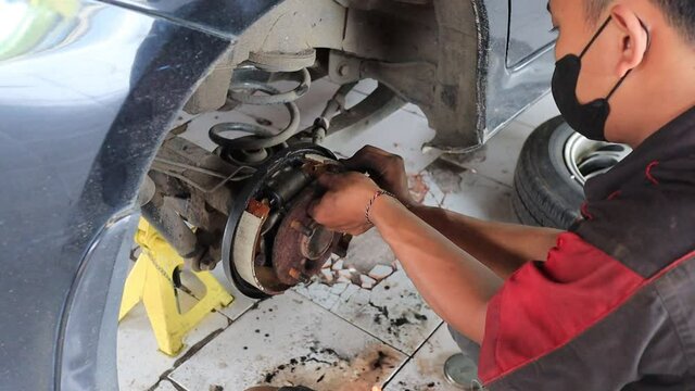 Process of changing new tires, Car brake repair in garage