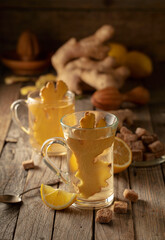 Ginger tea with ingredients on an old wooden table.
