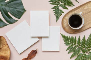 Styled summer wedding mockup. Blank greeting and invitation card. Green tropical leaves with invitation card on table.