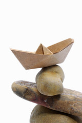 paper boat on zen stones