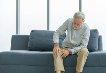 Caucasian old senior elderly unhealthy sick ill grey bearded male husband grandpa sitting on sofa...