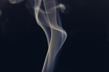 White smoke in front of the black background.	
