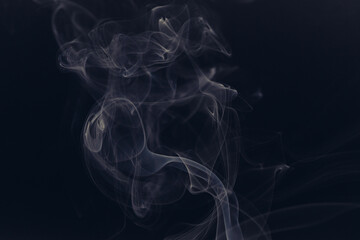 White smoke in front of the black background.	

