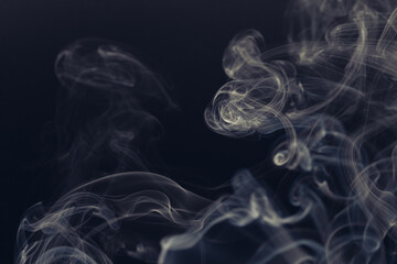 White smoke in front of the black background.	
