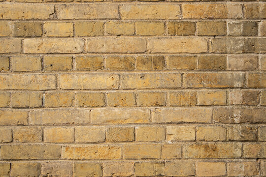 High resolution texture of a yellow brick wall background in the countryside