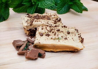  slices of Traditional South African Peppermint crisp tart or dessert on wooden surface garnished...
