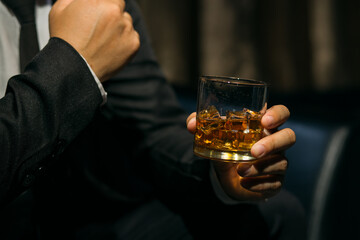 Businessmen in suits drinking whiskey