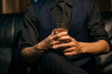 Businessmen in suits drinking whiskey