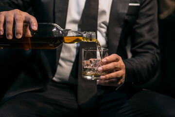 Businessmen in suits drinking whiskey