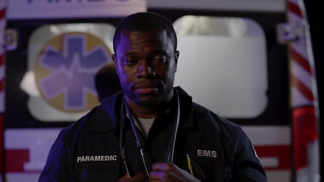 African paramedic with stethoscope on neck posing on street