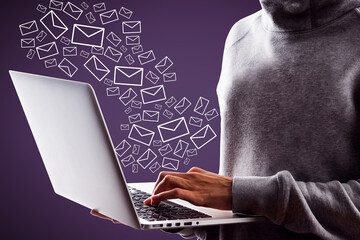 Close up of hacker hand using laptop with creative drawn email icons on purple background....