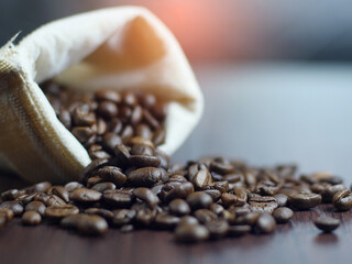 close up view of coffee beans out of the sack on the table