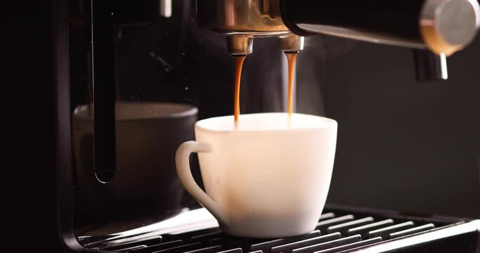 Detail of a professional coffe maker dripping coffe into an empty cup in a cafeteria, Machine is making a perfect coffee with delicious smell, . Espresso Coffee Machine Making Espresso Coffee