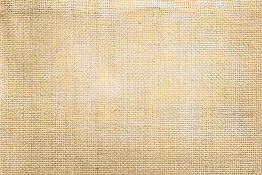 Jute hessian sackcloth canvas woven texture pattern background in light beige cream brown color blank empty