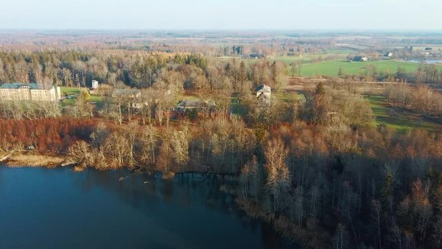 Old Red Brick House, Katvari Manor in Latvia and Katvaru Lake in the Background. View From Above. In the Manor Territory Is a Big Park With Hundred-year Old Linden. Aerial Dron Shot 4K Resolution