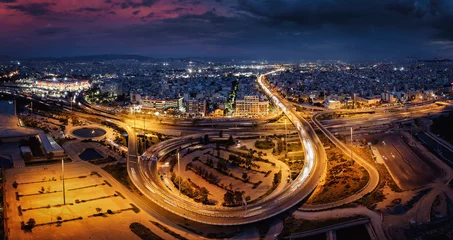 Gordijnen Aerial view of the Faliro interchange highway section in south Athens, Greece, during evening time with blurred traffic light trails © moofushi