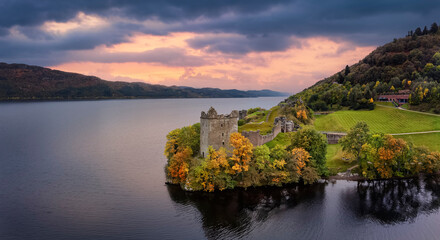 Aerial view of the impressive Urquhart Castle at the Loch Ness during autumn sunset time, Scotland - obrazy, fototapety, plakaty